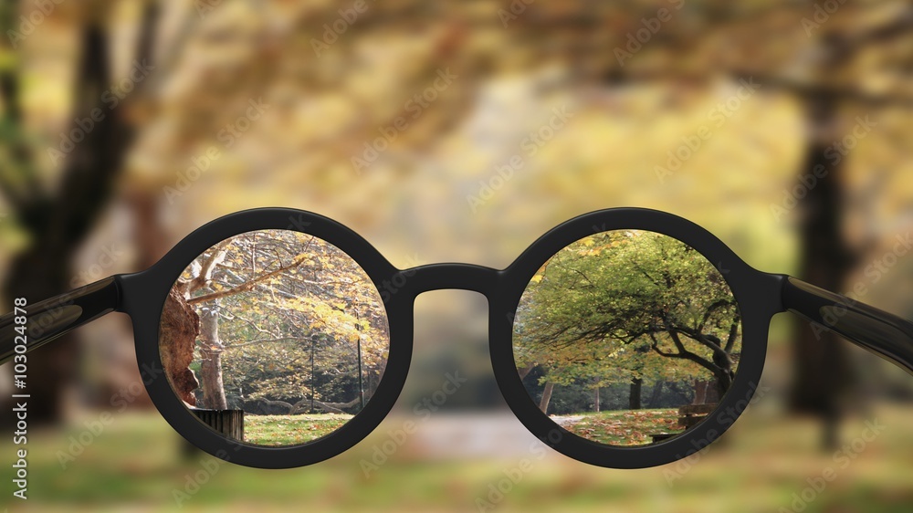 Closeup on eyeglasses with focused and blurred landscape view. - obrazy, fototapety, plakaty 