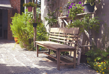 Wooden chair in the garden of hone with sunshine