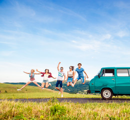 Wall Mural - Young hipster friends on road trip