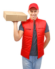 Wall Mural - Young handsome delivery man with a carton package, isolated on white