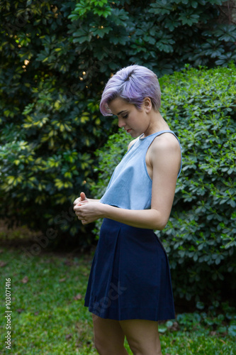 Violet Short Haired Girl Watching Her Hands Outdoors Buy This