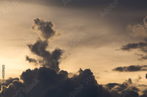 Fototapeta na wymiar golden dramatic sky with cloud shape dragon