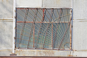 Old rusty window in the warehouse building