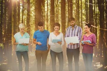 Poster - Composite image of group of young colleagues using laptops and tablets
