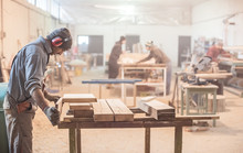 Man Doing Woodwork In Carpentry / Carpenter Work On Wood Plank In Workshop