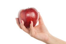 Woman's Hand Holding Red Apple. Isolated On A White Background.