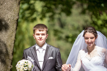 Happy beautiful  wedding girl in white dress and man in black suit