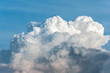 White cumulus congestus clouds on blue sky background.