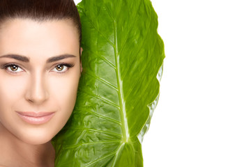 Wall Mural - beautiful spa girl with green leaf over white background