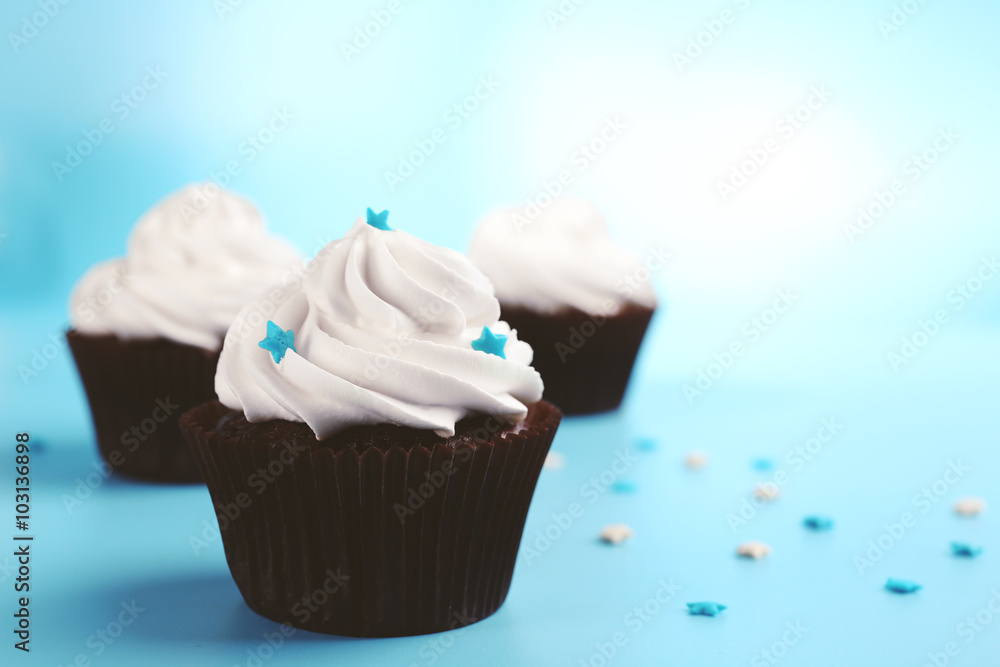 Chocolate cupcakes on blue background
