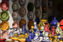 Tajines And Plates, Marrakech, Morocco, Africa.  A Market Stall In The Souk In The Potteries Section Selling Tajines And Plates Ornately Decorated.