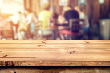 Wall Mural - top of wood table counter with blurred coffee shop (cafe) and restaurant shop interior background - 