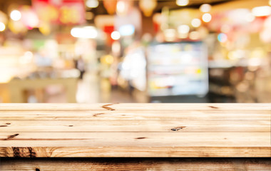 Wall Mural - empty wood table ready for your product display montage. abstract lights gray and white bokeh blurre