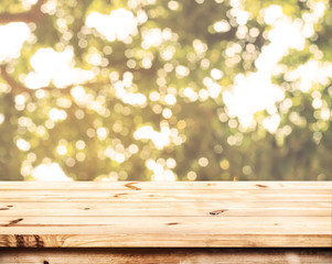Wall Mural - top of wood table with blurred bokeh nature background - empty ready for your product display or mon