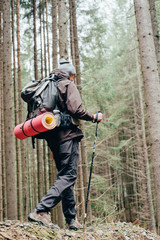Wall Mural - caucasian male hiking in mountains