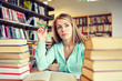 © Syda Productions - bored student or young woman with books in library