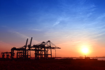 Wall Mural - Working cranes, in the evening