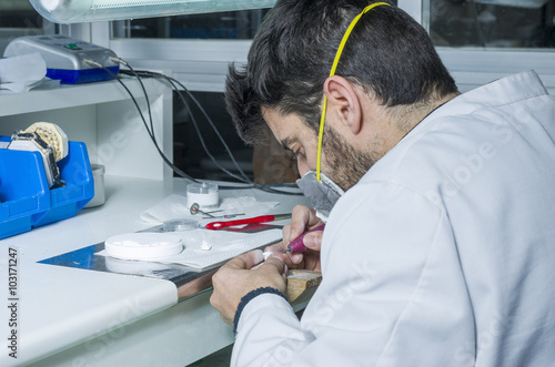 Fotografia, Obraz dental technician using dental burs with zirconium teeth.
