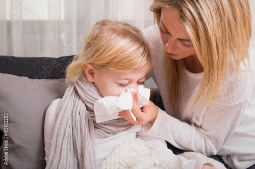 Fotografie, Obraz Mother helping her child to blow her nose