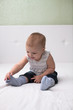 © natalialeb - Toddler baby pulls socks, independence, childhood, home, light