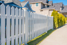 Wooden Fence With Green Lawn And Houses