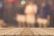 © tirachard - Wooden board empty table blurred background. Perspective brown wood over blur in department store - can be used for display or montage your products.Mock up for display of product.