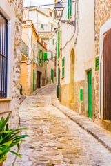 Fototapete - Alleyway with old paving stones of an mediterranean village