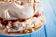 Pavlova meringue cake with cream and strawberries