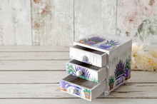 A Handmade Chest Of Trinket Drawers Decoupaged With Vintage Paperwith Pots Of Lavender On A Rustic Wooden Background