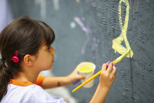 Young Girl Paints The  Wall