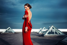 Gorgeous Elegant Woman In Red Long Dress With Diamonds On The Roof