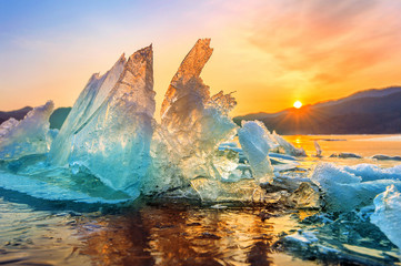 very large and beautiful chunk of ice at sunrise in winter.