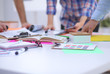 © lenetsnikolai - Close-up of three young creative designers working on project together. Team work
