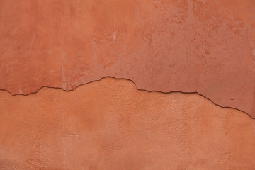 Wall Mural - Old terracotta painted stucco wall with cracked plaster. Backgro