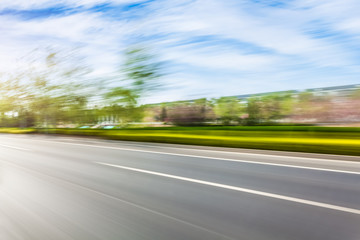 Car driving on road, motion blur