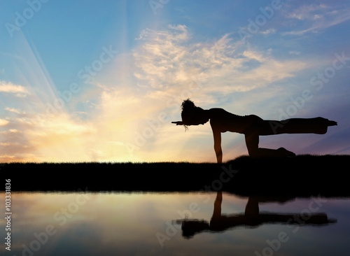 Fotografie, Obraz Silhouette of a girl practicing yoga
