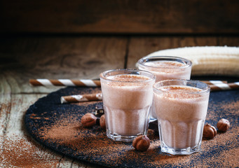 Banana chocolate smoothie with nuts, dusted with a powder, healt