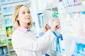 Wall Mural - female pharmacist with prescription in drugstore