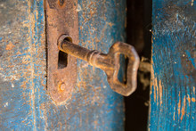 Old Rusty Key And Keyhole On A Blue Wooden Door