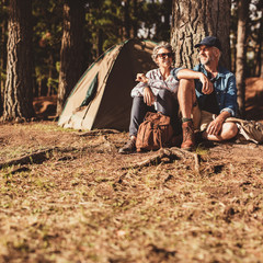 Wall Mural - Mature couple relaxing at their campsite