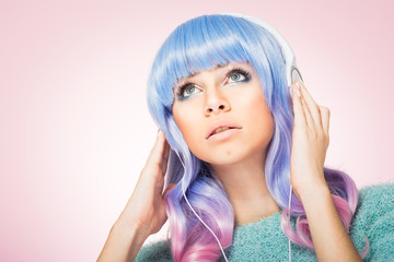 Gorgeous young woman with blue and pink hair and headphones