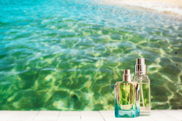 Perfume bottles against sea