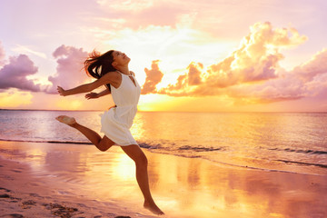 freedom wellness well-being happiness concept. happy carefree asian woman feeling blissful jumping o