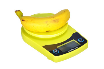 Nutrition diet concept : Banana on electronic kitchen scale isol