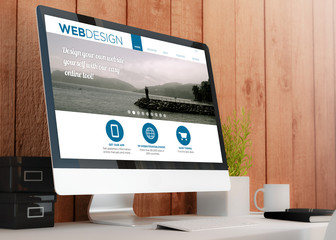 modern workspace with computer showing web design site