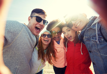 Wall Mural - happy laughing friends taking selfie
