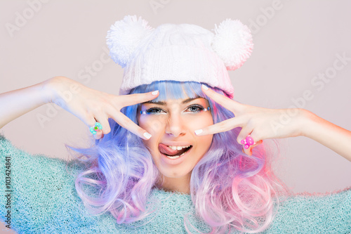 Fotografie, Obraz Modern young woman with pastel pink and blue hair and beanie