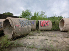 Industrial Cement Tubes With Painted Graffiti - Landscape Color Photo
