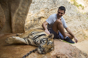 Man in Tiger temple in Thailand