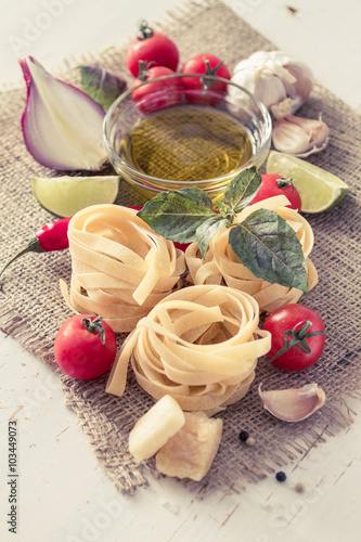 Nowoczesny obraz na płótnie Pasta and ingredients on rustic background